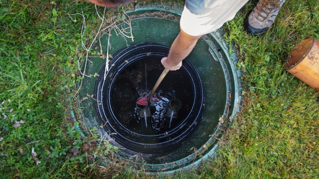 technician cleaning septic tank