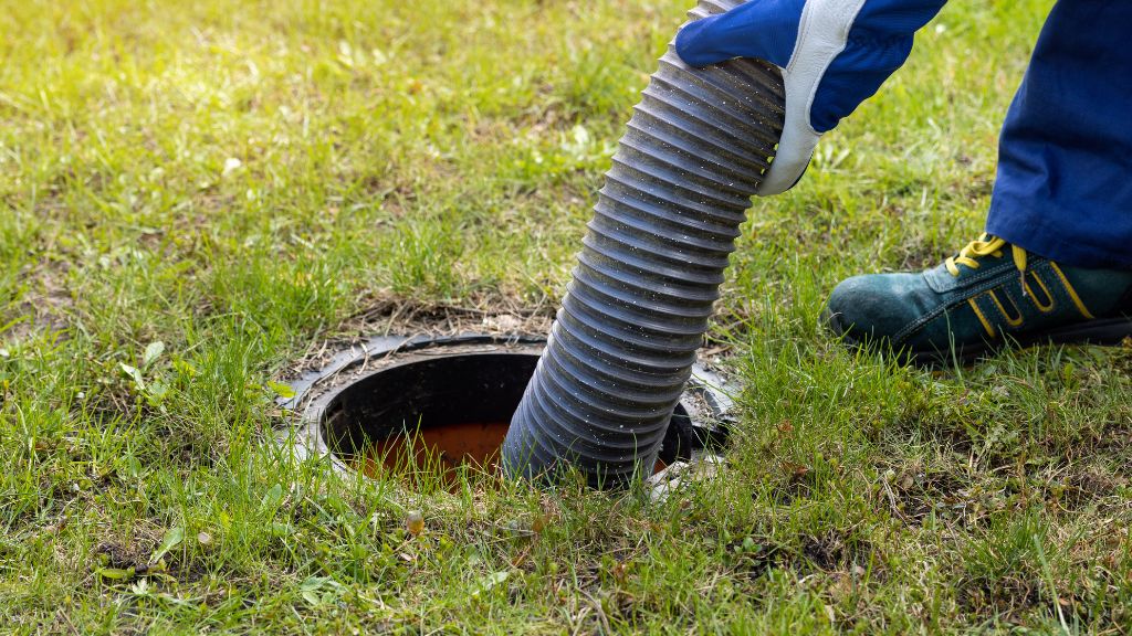 technician servicing an older septic system